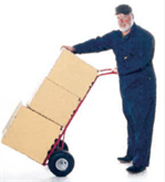 Man using a cart to move many boxes.