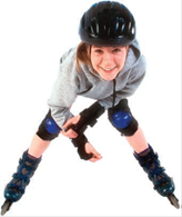 Girl riding rollerblades wearing helmet and knee pads.